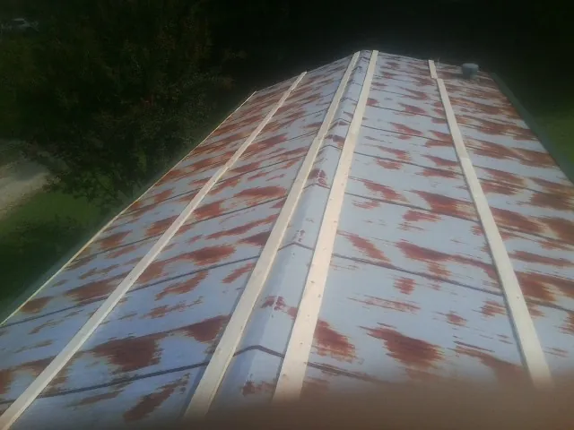 Rusted metal roof panels with new wood purlins before replacement — Storm Damage Roof Repair in Hagerman by Roofing Brothers